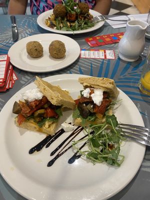 Vegan focaccia, Lebanese flat bread & aranchini balls   at Planted Community Cafe, Refillery and Hub in Cheltenham