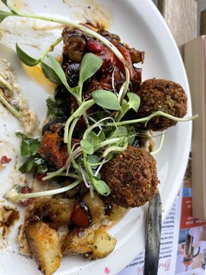 The Lebanese falafel flatbread (half eaten)  at Planted Community Cafe, Refillery and Hub in Cheltenham