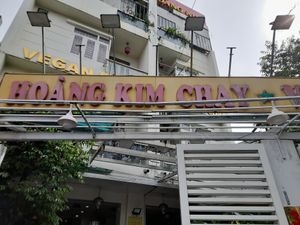 Old faded sign at the front at Cơm Chay Hoàng Kim in Ho Chi Minh City