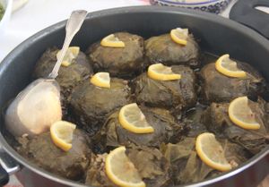 Artichoke stuffed and wrapped in vine leaves — a delicate plant-based twist on Turkish dolma. Layered with care, topped with thin lemon slices, and cooked slowly in olive oil.  at Delidolu Wholesome Kitchen in Bodrum