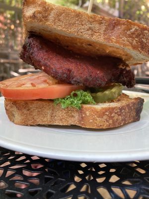 old major house burger made with cannellini beans and beets and a vegan sauce. Made vegan by swapping out the milk-based bun with vegan sourdough bread and holding cheese sauce at Heart of Gold in Cleveland