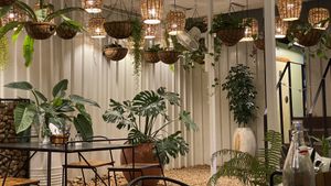 Night photo with lit seated area  at Alra Cafe in Viluppuram