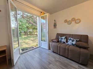 The lounge with a new convertible sofa. Opens onto the garden at the back of the house. 
 at Vegocéane  in Saint-michel-chef-chef