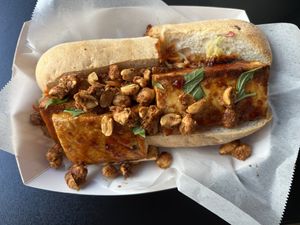 Thai BBQ Tofu- Locally Made Tofu Marinated in a Thai BBQ Sauce served with Lemongrass and Thai Chili Mirliton Slaw, Spiced Peanuts and Coconut  at Killer Poboys in New Orleans