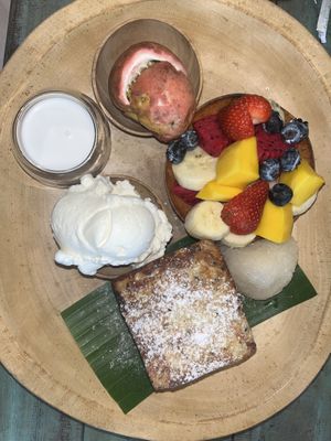 Mango French toast with a fruit bowl, coconut ice cream, coconut milk and sticky rice + peach iced tea (not pictured) best I’ve ever had!  at Mango in Bangkok
