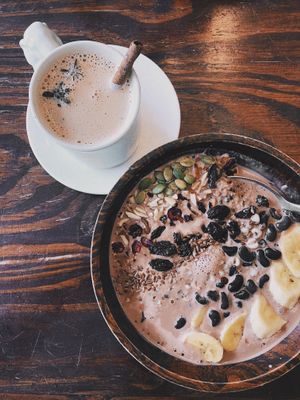 Chai latte with almond milk & Banana Cacao Quinoa Porridge. Super satiating?  at Mango in Bangkok