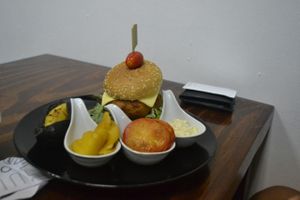 my friend's dish: falafel burgeer. would have been vegan minus the cheese.  at Mango in Bangkok