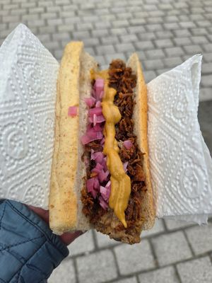 Vegan hot dog with vegan bread topped with crispy onions, pickled onions and mustard at Raketten Bar & Pølse in Troms