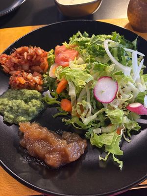 Salad items from the lunch buffet, including onion chutney, cilantro chutney, and mango chutney at Lazeez in Rocky Mount