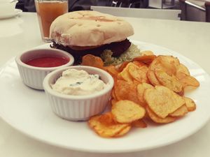 Lush falafel burger with papas criollas chips   at Herbívoro -  Av. Suba in Bogota