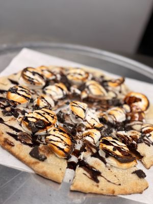 Vegan Campire Edition - 
Vegan marshmallows, glazed with vegan chocolate sauce, sprinkled with vegan cookie crumble (All vegan products are soy free) at On The Run Pizza - Ghost Kitchen in Las Vegas