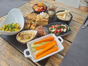 Breakfast platter, tofu scramble, pancakes, fruit salad, vegetable roll, homemade mozzarella, porridge, yoghurt with granola and berries at Villa Vegana in Mallorca