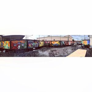 The back patio at Harold's Coffee Lounge. The back fence is full of murals that get changed throughout the year. at Harold's Coffee Lounge in West Palm Beach