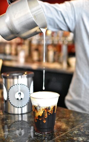 Kyoto Style Cold Brewed Coffee with Oat Milk Cold foam on top. We have all kinds of vegan milk alternatives like Almond, Soy, Oat, Hemp, Cashew, Coconut and more. at Harold's Coffee Lounge in West Palm Beach