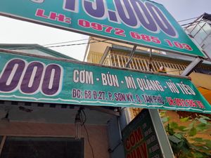 Old faded sign outside at Com chay Vạn Duyen in Ho Chi Minh City