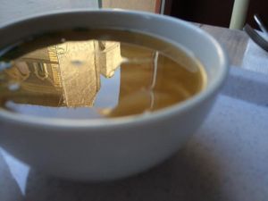 Miso soup with the reflection of a beautiful building in it.  at Rizsa17 in Budapest