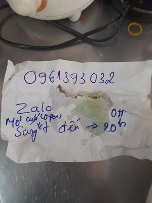 Owner wrote down the correct information with phone number and opening times at Quán Chay Tâm Phuc in Ho Chi Minh City