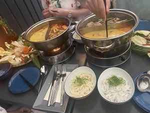 Two hot pots with kokos-curry, pho, and sweet&sour  at Vevi - Kaiserstrasse in Vienna