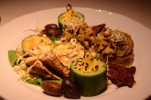 Snack Platter (Part 2)-- fava bean & mushroom pâté, fried tofu, cucumber cups with cashew cream, grilled zucchini with cashew cheese, sun-dried tomatoes, olives at Vegan Restoran V in Tallinn