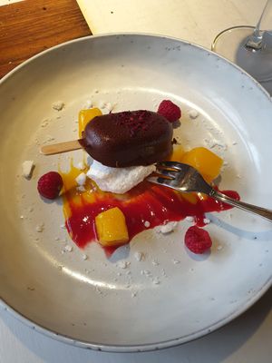 Passionfruit “cheesecake bite” with mango & raspberry sauce and meringue at Vegan Restoran V in Tallinn