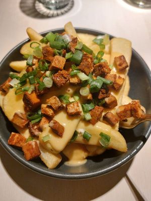 Fries with vegan cheese sauce and tofu. at Vegan Restoran V in Tallinn