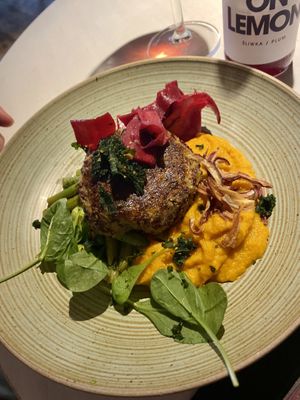 Quinoa turnip cutlet with roasted carrot puré and warm bean cabbage salad  at Vegan Restoran V in Tallinn