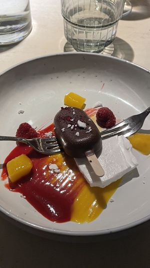 Dessert: meringue, ice cream, mango and rasberry  at Vegan Restoran V in Tallinn