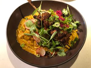 Peanut-orange marinated soy skewers in a slightly spicy curry sauce with rice noodles and red cabbage kimchi at Vegan Restoran V in Tallinn