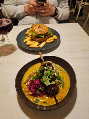 Vegan pineapple burger and peanut-orange-marinated soy skewers with noodles and curry at Vegan Restoran V in Tallinn