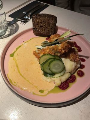Breaded ´´chicken´´ with herb sheese, potato puree, sun-dried tomato sauce, pickles and Estonian style bread.  at Vegan Restoran V in Tallinn