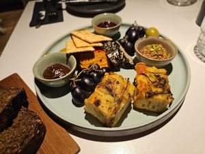 Snack platter: handcrafted cashew sheeses: chipotle pepper and truffle flavor, homemade jams: cognac-cranberry-orange red wine onion-plum, pâté, rosemary bread, crackers at Vegan Restoran V in Tallinn