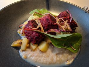 Jackfruit-beet-chickpea balls with potatoes, smoky onion cream and herb hummus at Vegan Restoran V in Tallinn
