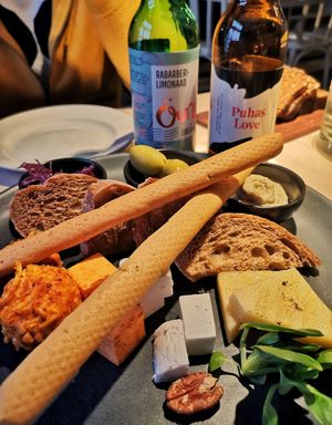 Cheese platter for two: (starter) Cashew cream cheese, peanutbutter-cheese ball, grilled vegan halloumi, vegan greek style cheese, vegan cheese, olives, onion jam, grissini, ciabat at Vegan Restoran V in Tallinn