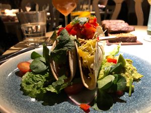 Spicy oven-baked seitan tacos with cheese, guacamole and mango salsa  at Vegan Restoran V in Tallinn