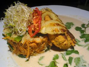 Spicy tofu patty and grilled pineapple with quinoa and peanut sauce. at Vegan Restoran V in Tallinn