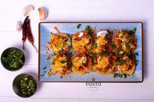 Dahi Poori - A popular Indian street food made of crisp, hollow puris filled with spiced potatoes and chutney and yoghurt at Posto Bistro in Prague
