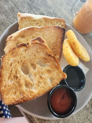 Ciabata with jam and hash browns at Chill At Portofino in Palm Cove