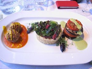 Bulghar wheat with wilted kale, 'no-meat' balls with tomato sauce and a veggie stack with pea puree. at Gare du Nord in Rotterdam