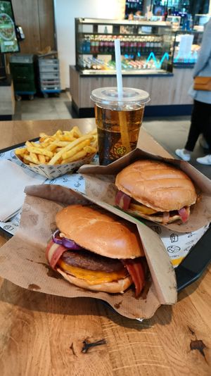 Two Vincent super mash burgers with extra bacon, crunchy fries and ginger ale at VINCENT -  Hauptbahnhof in Berlin