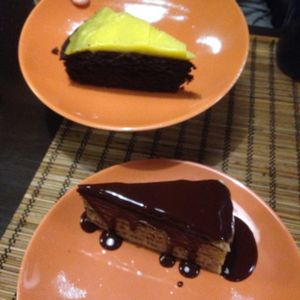 Layered pancakes and chocolate cake with orange cream  at Kozmosz Vegan Etterem in Budapest