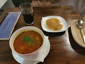 Goulash, pitta bread, grape juice at Kozmosz Vegan Etterem in Budapest