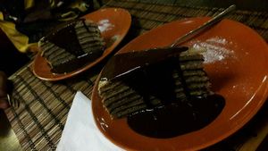 Layeres pancake with poppy seed, abricot jam and chocolate sauce  - mmmmh at Kozmosz Vegan Etterem in Budapest