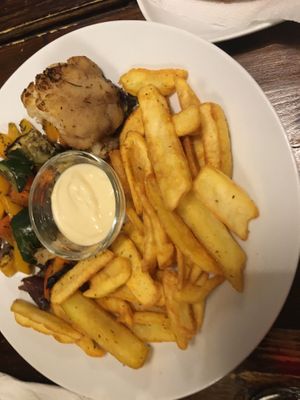 Oven-baked veggie plate with fries and garlic sauce  at Kozmosz Vegan Etterem in Budapest