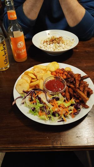 barbecue seitan ; "cottage cheese csusza" ; Fritz-limo orange flavored at Kozmosz Vegan Etterem in Budapest