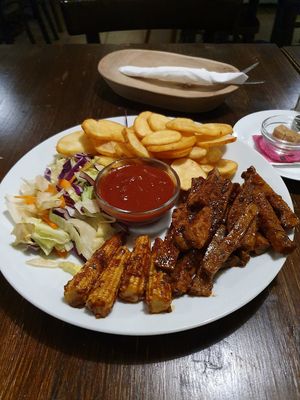 Bbq seitan and fried potatoes. Yummo. at Kozmosz Vegan Etterem in Budapest