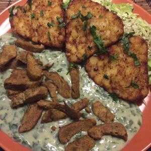 Austrian week special. Potato cake with Seitan on spinach cream sauce.  at Kozmosz Vegan Etterem in Budapest