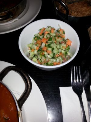 Israeli Salad comes with the Vegetable-patty in Tomato,  plus  Tahini, plus Olives at Café Schneor in Tel Aviv