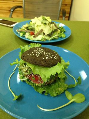Burger with whole grain bread plus mix-salad  at The Green House in Almaty