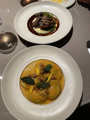 pumpkin ravioli, grilled funghi on smashed potatos behind  at lara  in Vienna