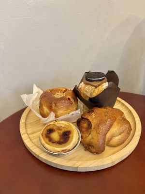 A selection of pastries. Chocolate cruffin, pumpkin bun, peanut bun and pastel de nata  at Moko Vegan Bakery in Lisbon